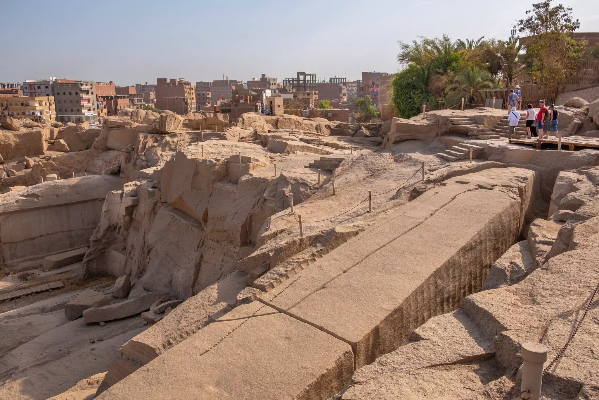 ASWAN, EGYPT - JUNE 4, 2019: Tourists admiring the unfinished obelisk in a quarry at Aswan, License Type: media, Download Time: 2026-03-15T18:47:53.000Z, User: bhealy950, Editorial: true, purchase_order: 65050 - Digital Destinations and Articles, job: Lonely Planet Online Editorial, client: Best things to do in Aswan, other: Brian Healy