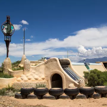 TAOS, NEW MEXICO-AUGUST 13: Building materials sit outside an earthship being built in Taos on August 13, 2014. Earthships are environmentally friendly homes made of recycled materials.