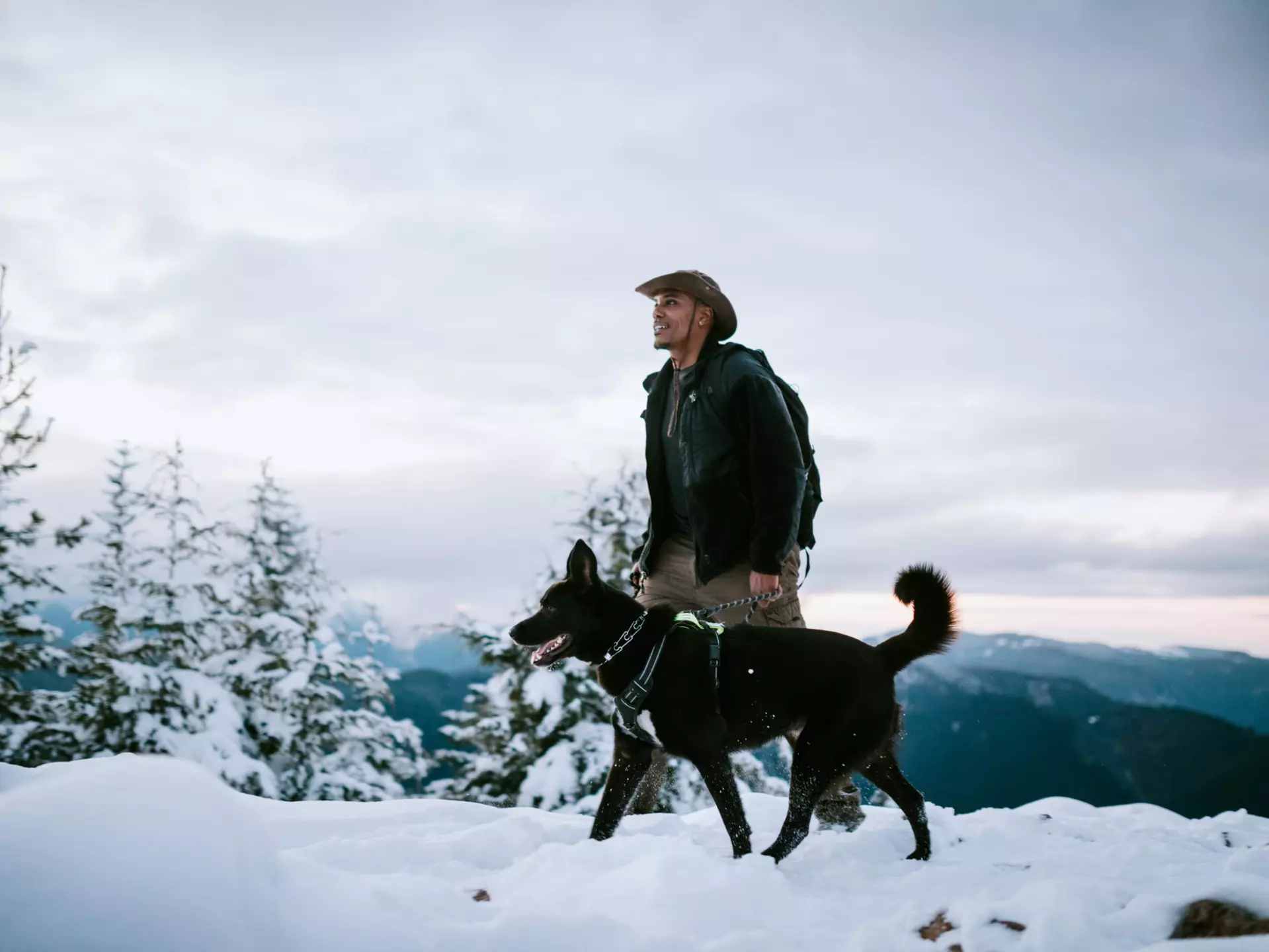 An African American man and his dog hiking in the snow covered mountain areas of Washington state, USA.  An exciting winter adventure.
CLEARED FOR DIGITAL USE ONLY -