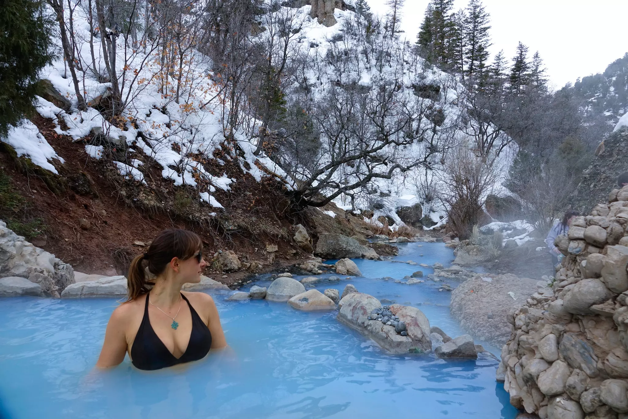 A woman relaxes in the soothing hot water of Fifth Water Springs in Utah.