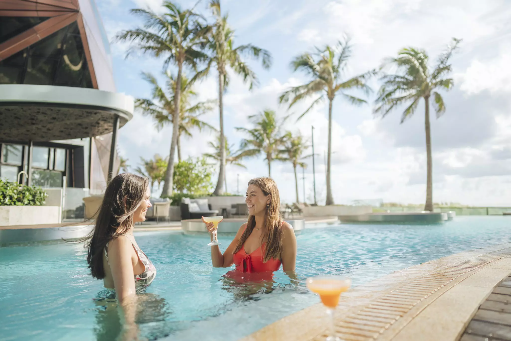 Poolside drinks (as at the newly opened Langham) are a part of the Palm Springs–esque vibe. What’s not to love? © Tourism and Events Queensland