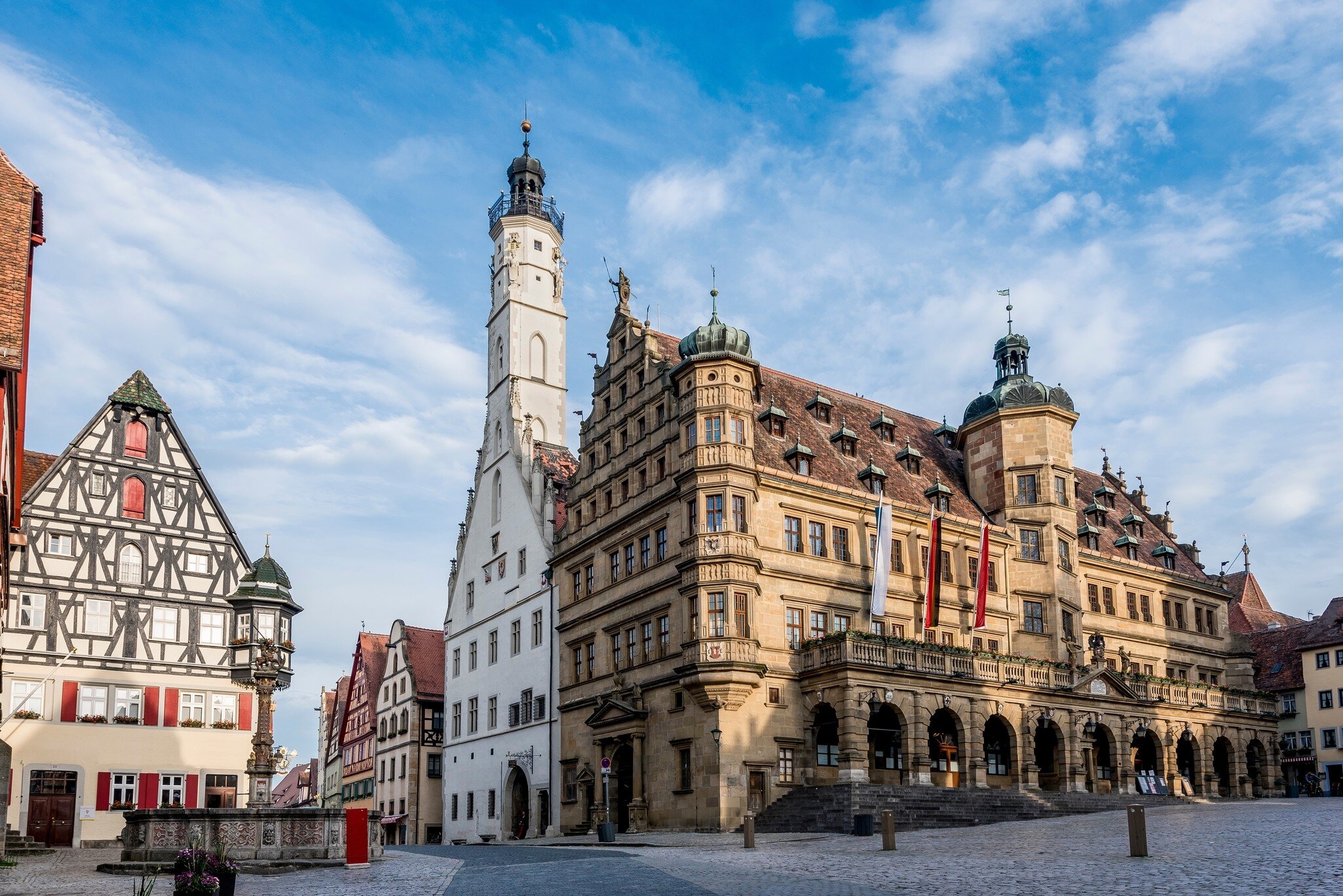 The town hall of Rothenburg ob der Tauber in the historic old town with the market square in the foreground, Germany.