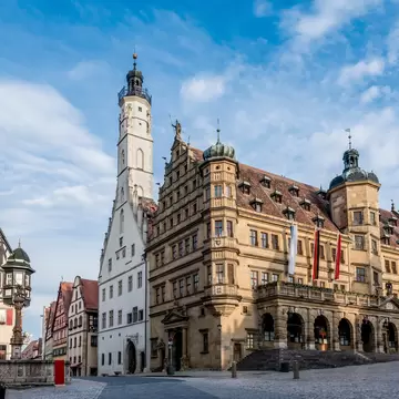 The town hall of Rothenburg ob der Tauber in the historic old town with the market square in the foreground, Germany.