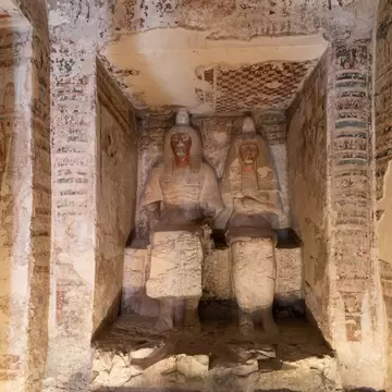statues of  (Amenemopet) the Chief Steward of Amun and is wife in his tomb Valley of Nobles in Thebes - Luxor . Egypt .