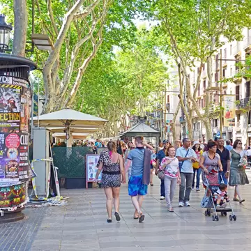 Barcelona, Spain - June 17, 2015: The always crowded, La Rambla in Barcelona is one of the more popular tourist draws to the city and is always filled with interesting characters and vendors.