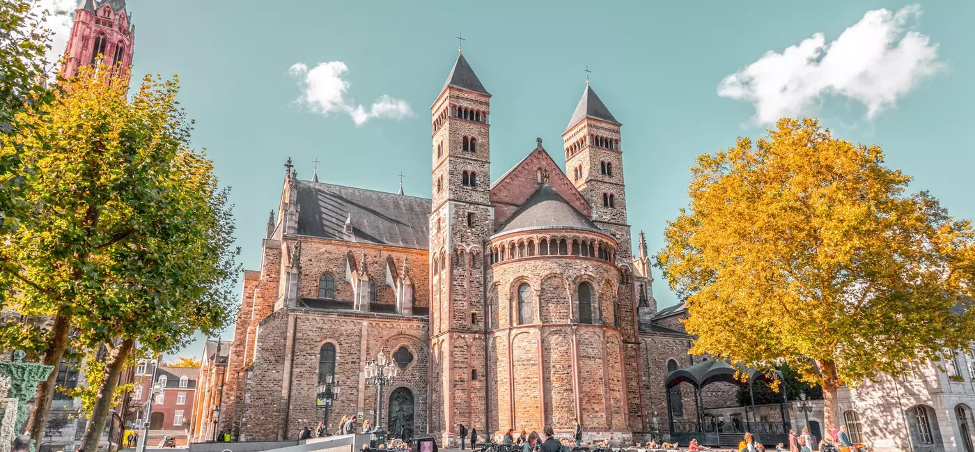 Bicycles and people outside Sint Servaas basilica and the St. John Church at the Vrijthof Square