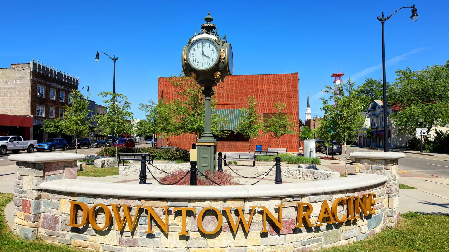 A sign that reads Downtown Racine in front of a small clock tower in Racine, Wisconsin