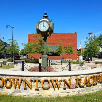 A sign that reads Downtown Racine in front of a small clock tower in Racine, Wisconsin