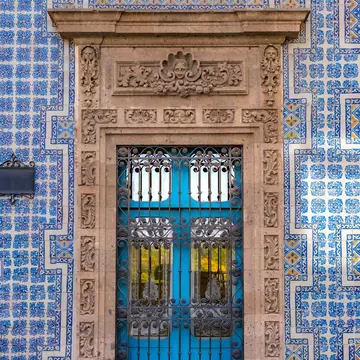 February 19, 2017: Part of the facade of La Casa de los Azulejos or Palacio de los Condes de Orizaba on a sunny day in Mexico City.