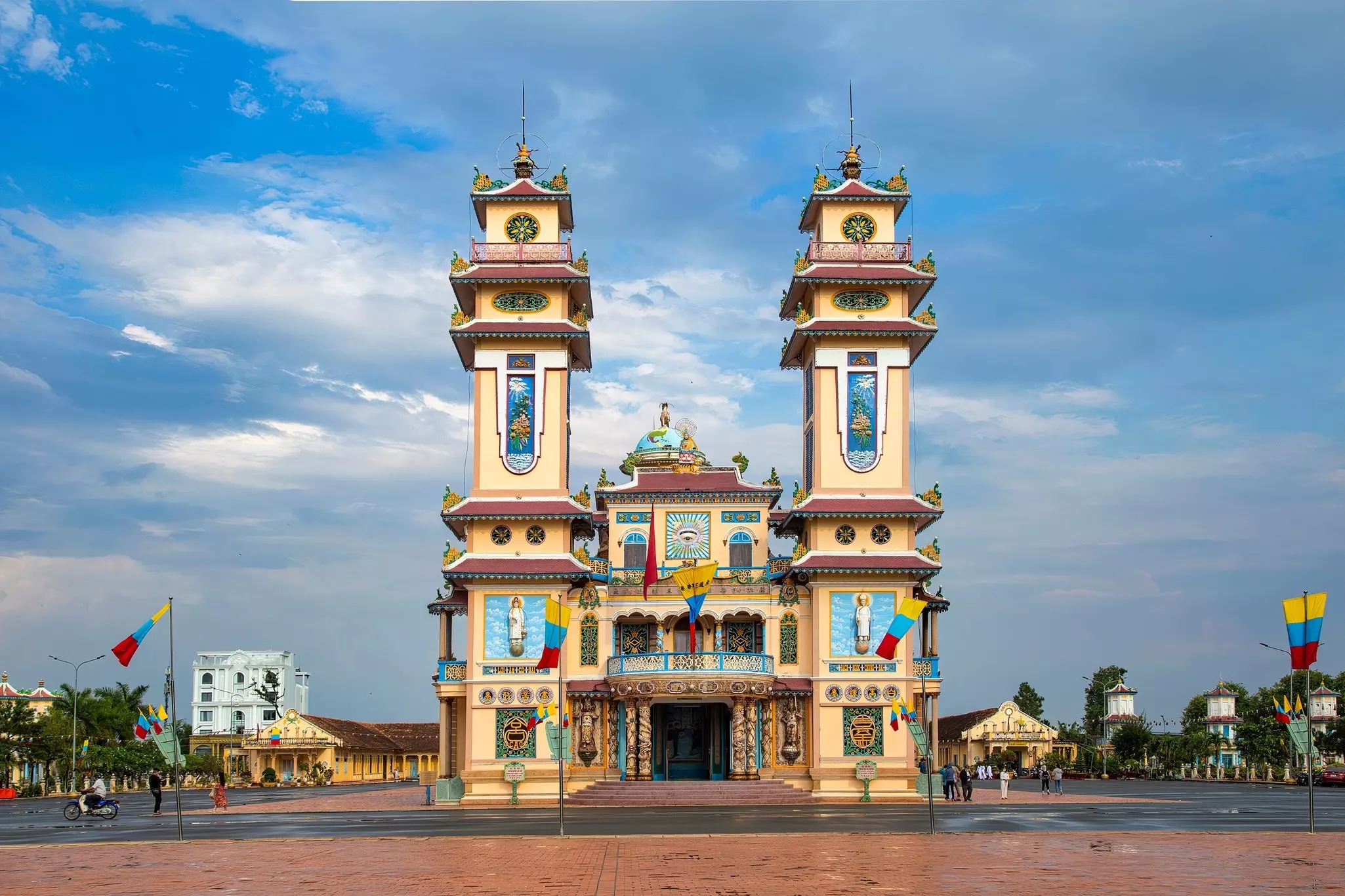 Cao Dai temple area and meditating followers of the Cao Dai religion in the temple Cao Dai, Tay Ninh, Vietnam.