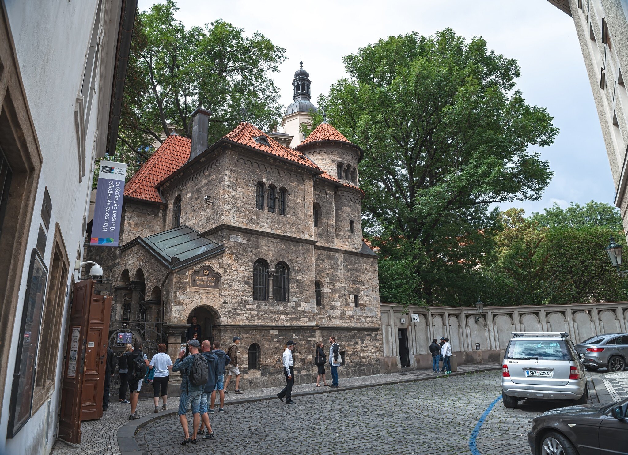 Prague, Czech Republic.  Tourists walking in front of the Klaus Synagogue, Josefov Jewish quarter of Prague.