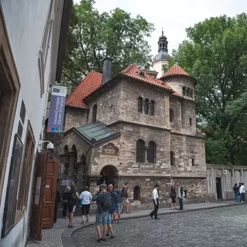 Prague, Czech Republic.  Tourists walking in front of the Klaus Synagogue, Josefov Jewish quarter of Prague.