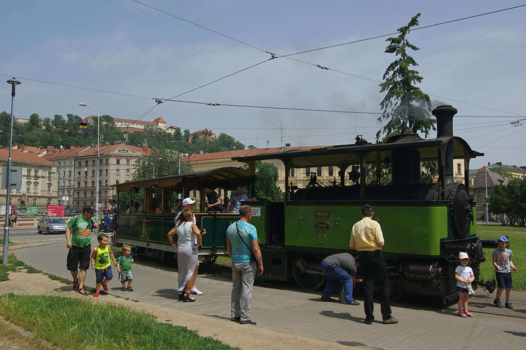 People in front of the vintage steam tram at the Technical Museum and provides nostalgic flight commemorating the local public transport company 150 years.  Brno, Czechia.