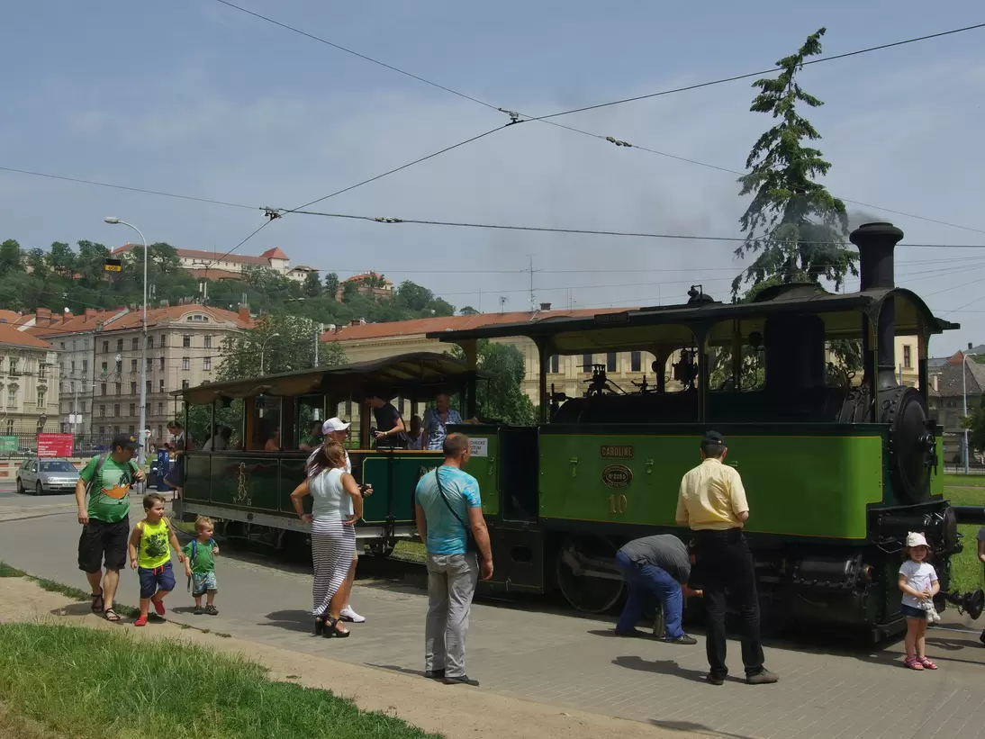 People in front of the vintage steam tram at the Technical Museum and provides nostalgic flight commemorating the local public transport company 150 years.  Brno, Czechia.