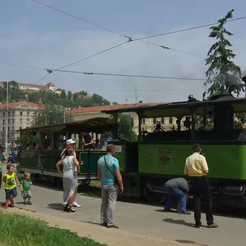 People in front of the vintage steam tram at the Technical Museum and provides nostalgic flight commemorating the local public transport company 150 years.  Brno, Czechia.