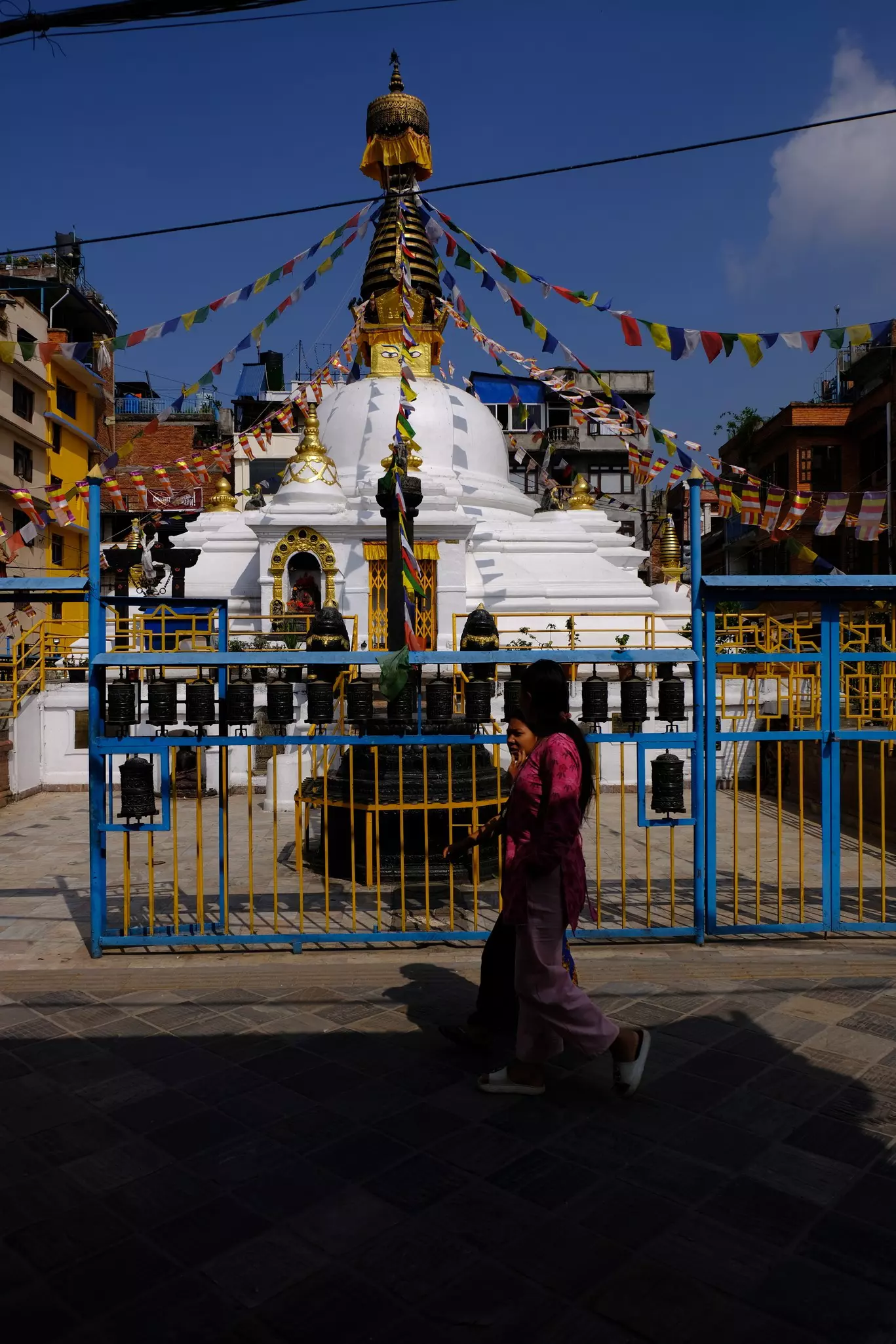 Spinning prayer wheels at the Ashok Chaitya in Pim Bahal, Patan, Nepal.