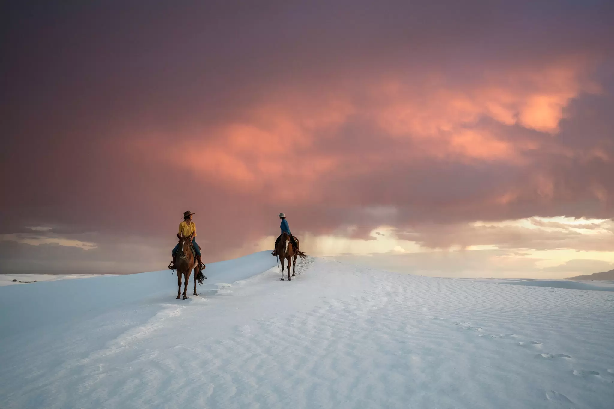 Men on horse back in White Sands