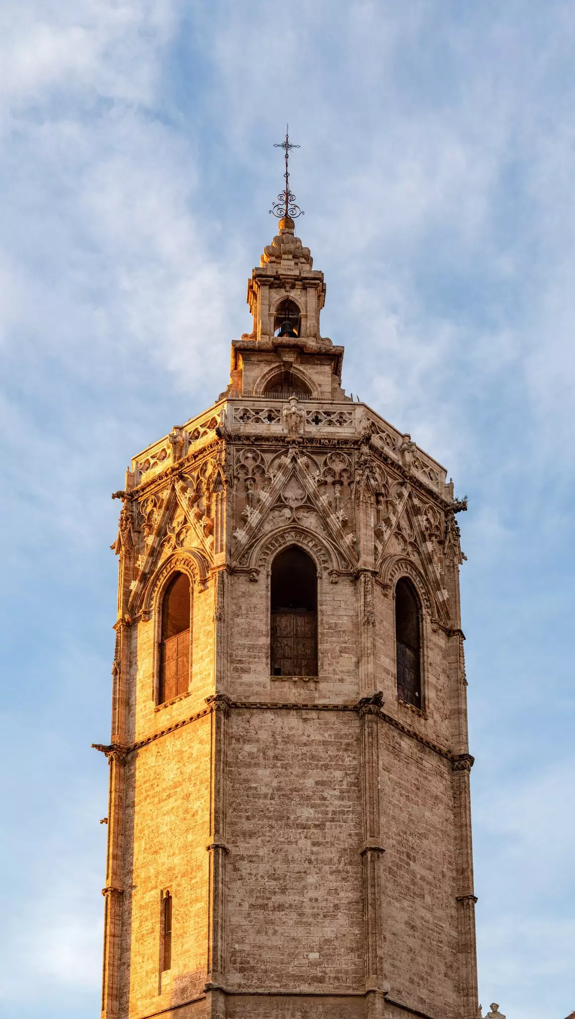 The Miguelete bell tower of Valencia Cathedral at sunset, Valencia, Spain. A Gothic architecture landmark in the historic center illuminated by sun.