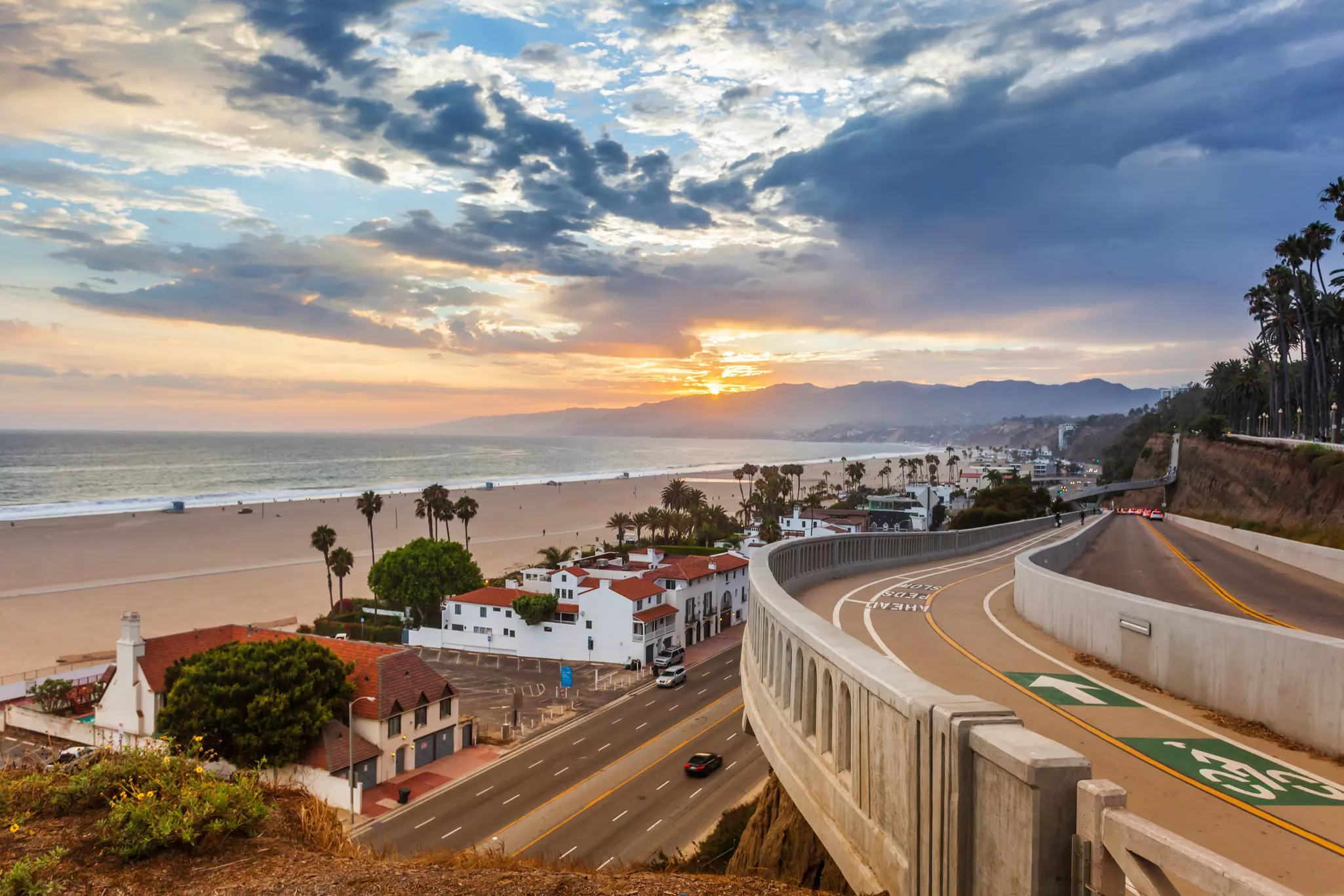 Sunset in Santa Monica, with a view of the beach, the ocean, the highway and houses