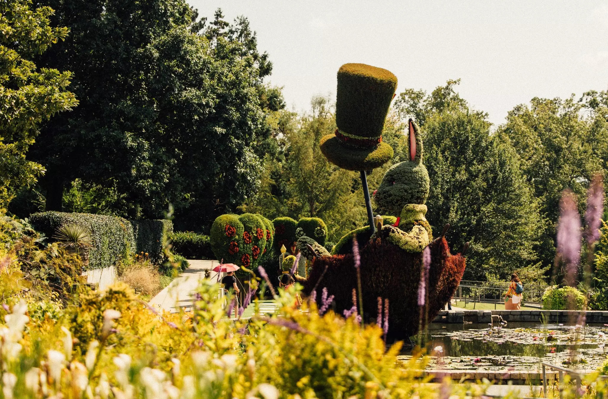 A water feature and floral display at a botanical garden depicts characters from “Alice in Wonderland.”