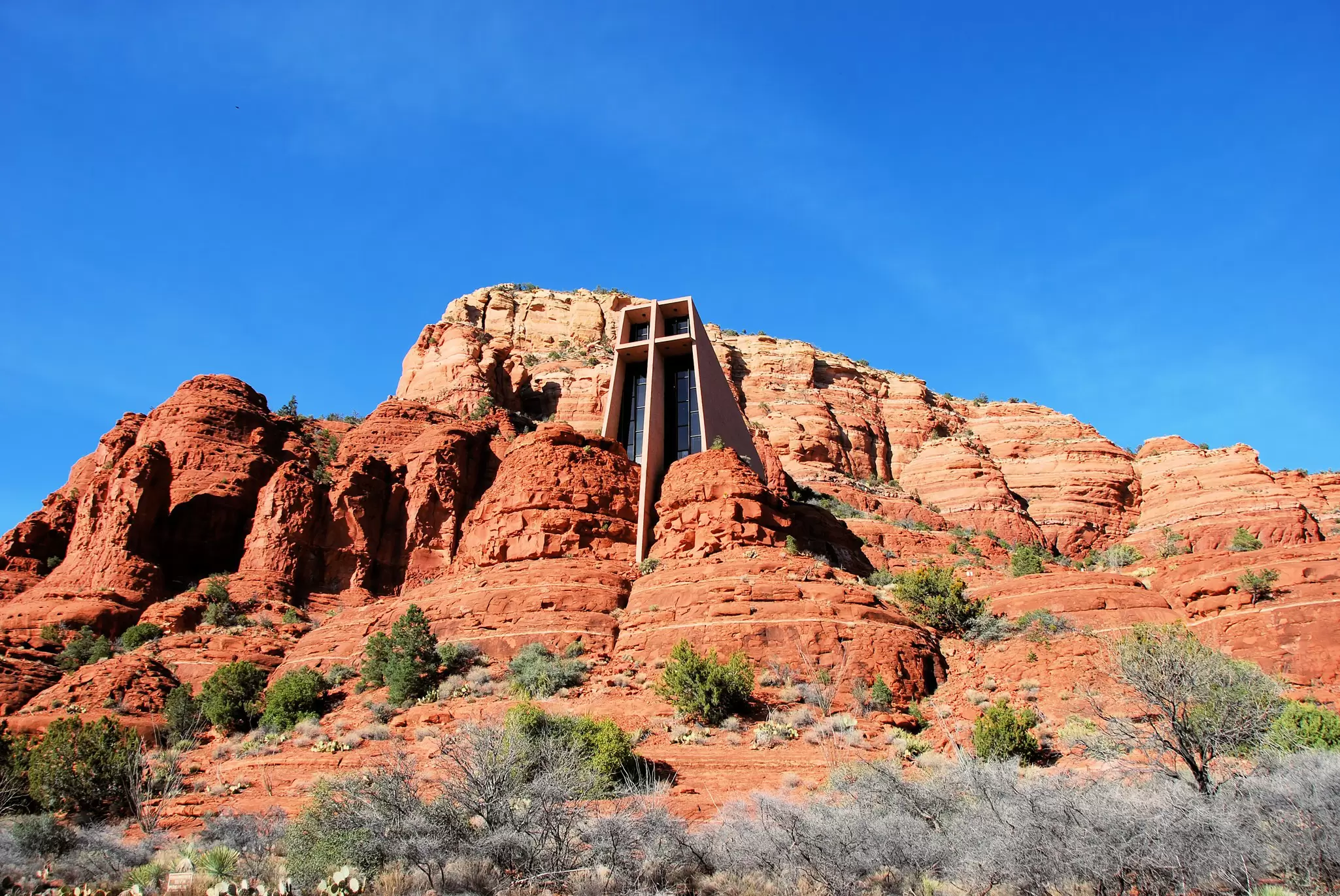A structure built into a red-rock cliff