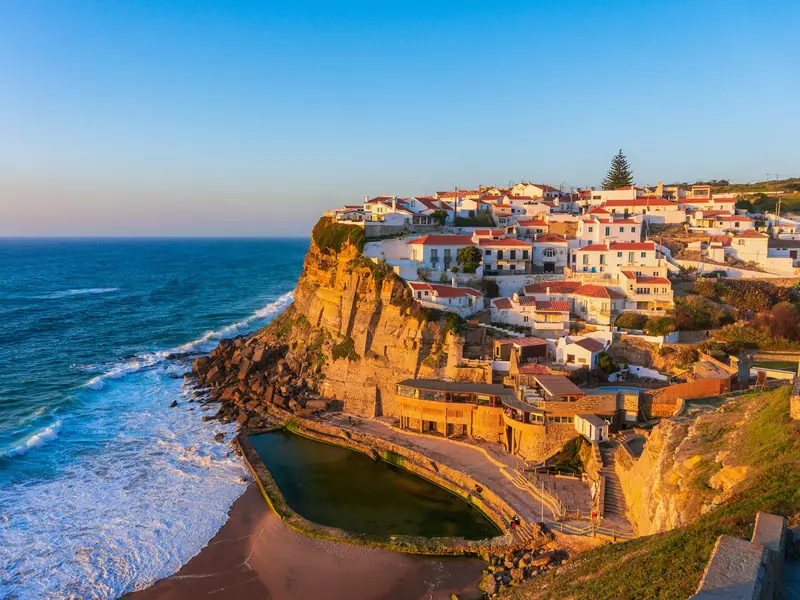 A clifftop village at sunset, with whitewashed buildings overlooking the Atlantic Ocean