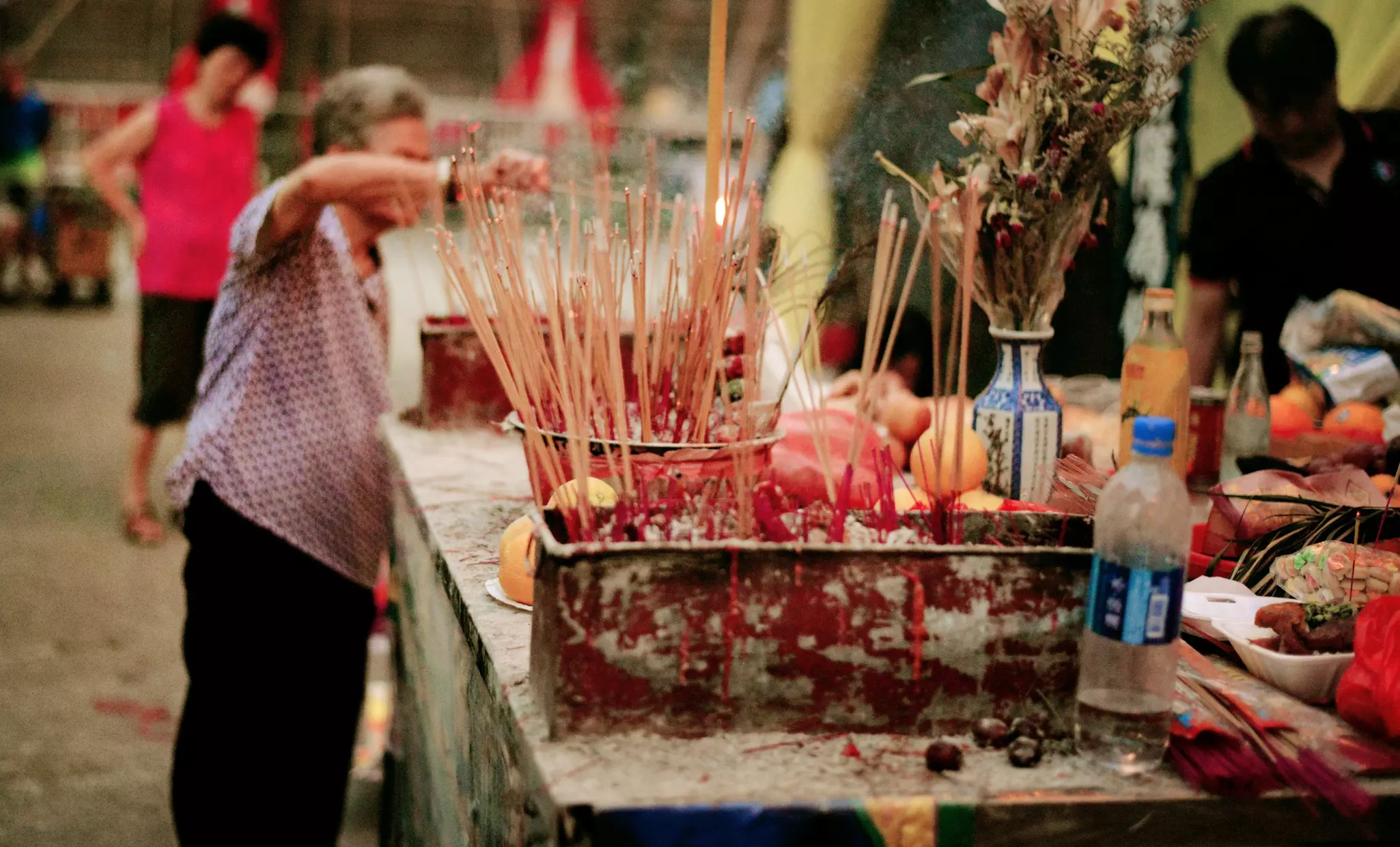 A woman burns incense during the Hungry Ghost Festival in Hong Kong. Cheryl Chan/Getty Images