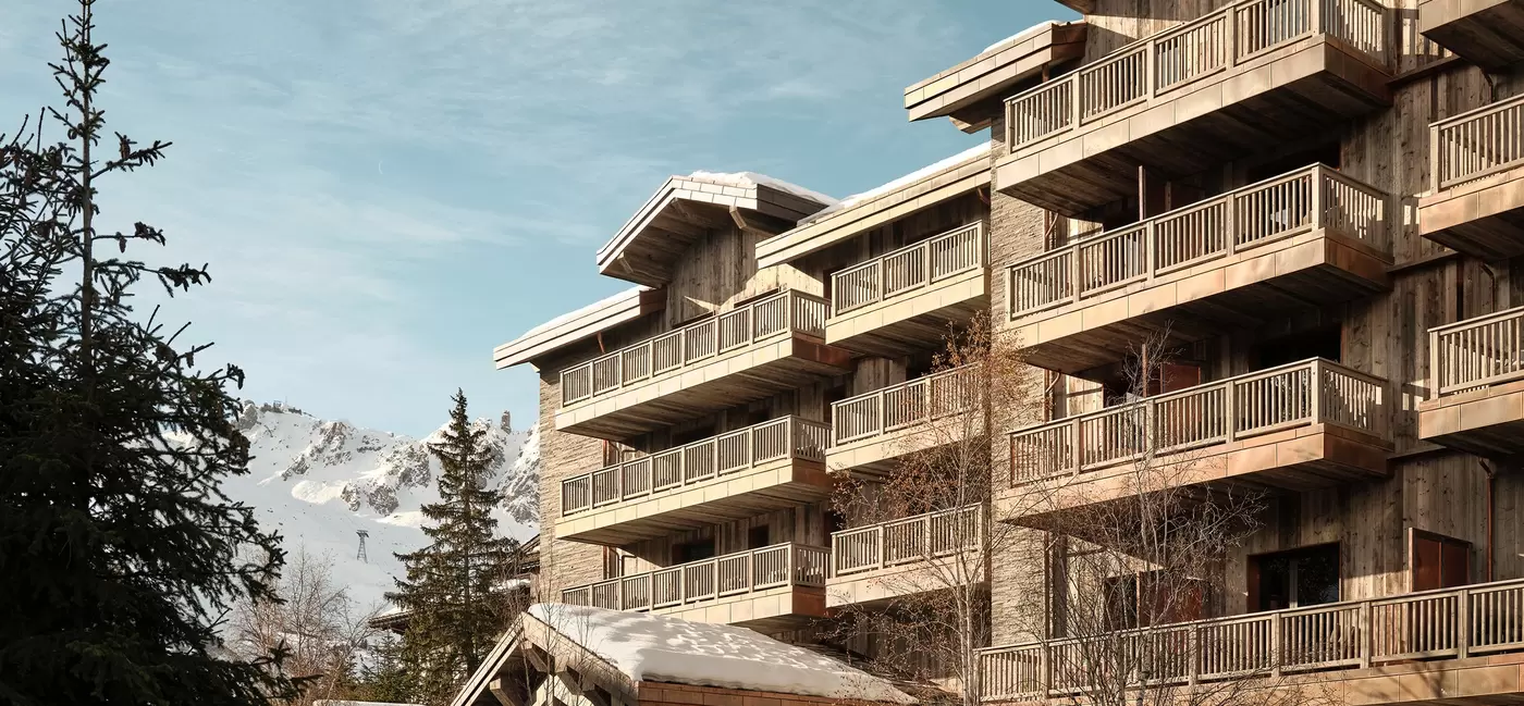 Exterior of a chalet-style hotel in a snowy landscape: Rosewood Courchevel, the French Alps