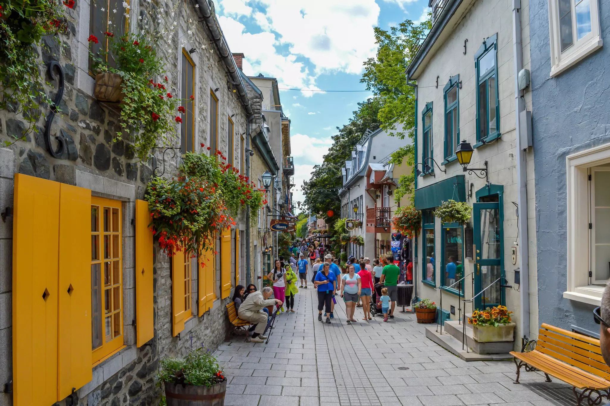 People walking along a narrow street in the Old Town neighborhood of Québec City.