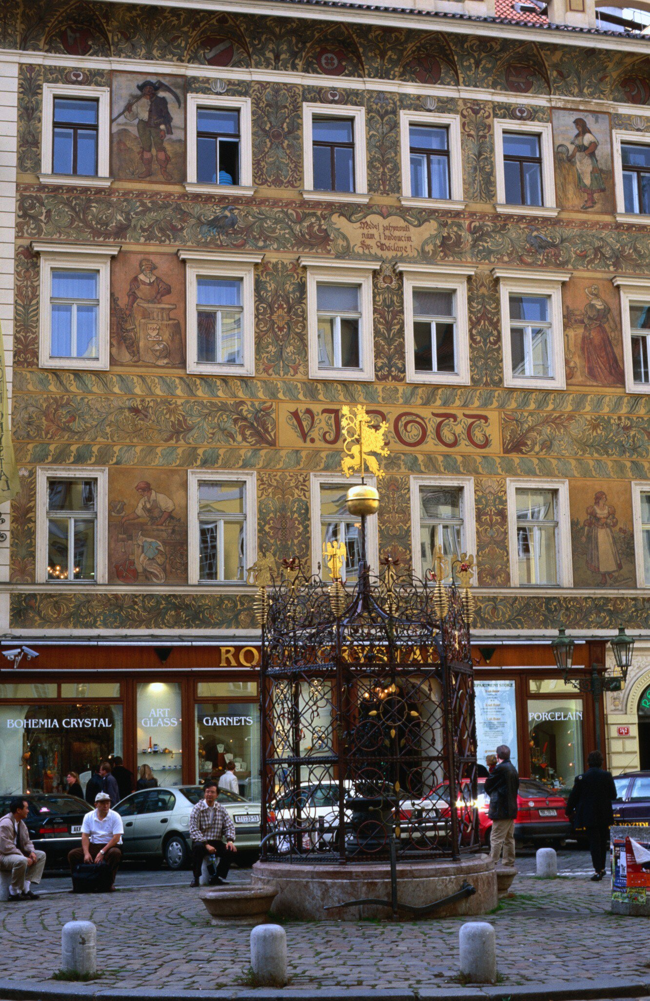 The facade of the VJ Rott building and well in Male Square in Prague, Czechia.