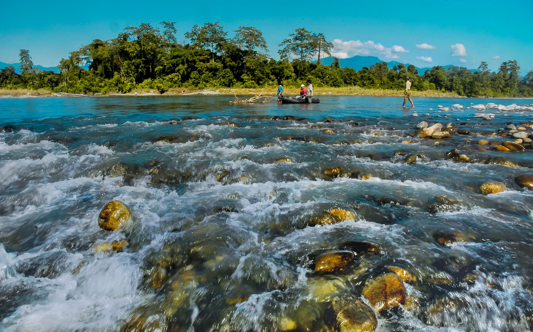 Water crashing over rocks in a landscape image of Nameri National Park, Assam, India.