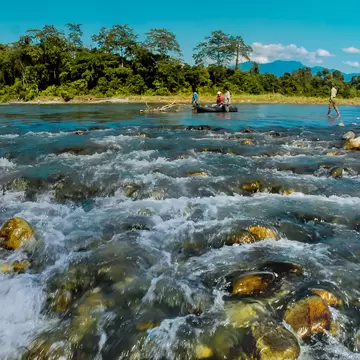 Water crashing over rocks in a landscape image of Nameri National Park, Assam, India.