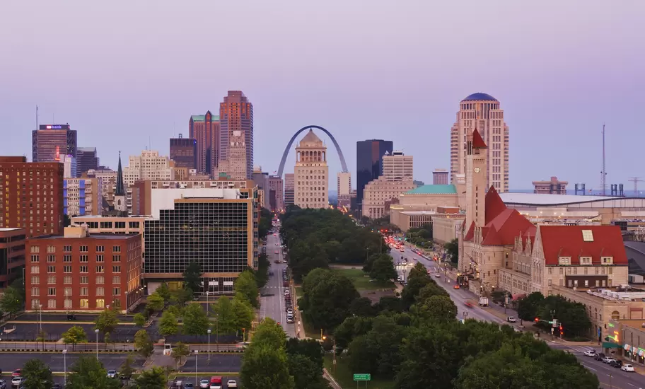 Downtown St Louis, Missouri, at dusk, with the Gateway Arch behind the Civil Courts Building and Union Station clock tower