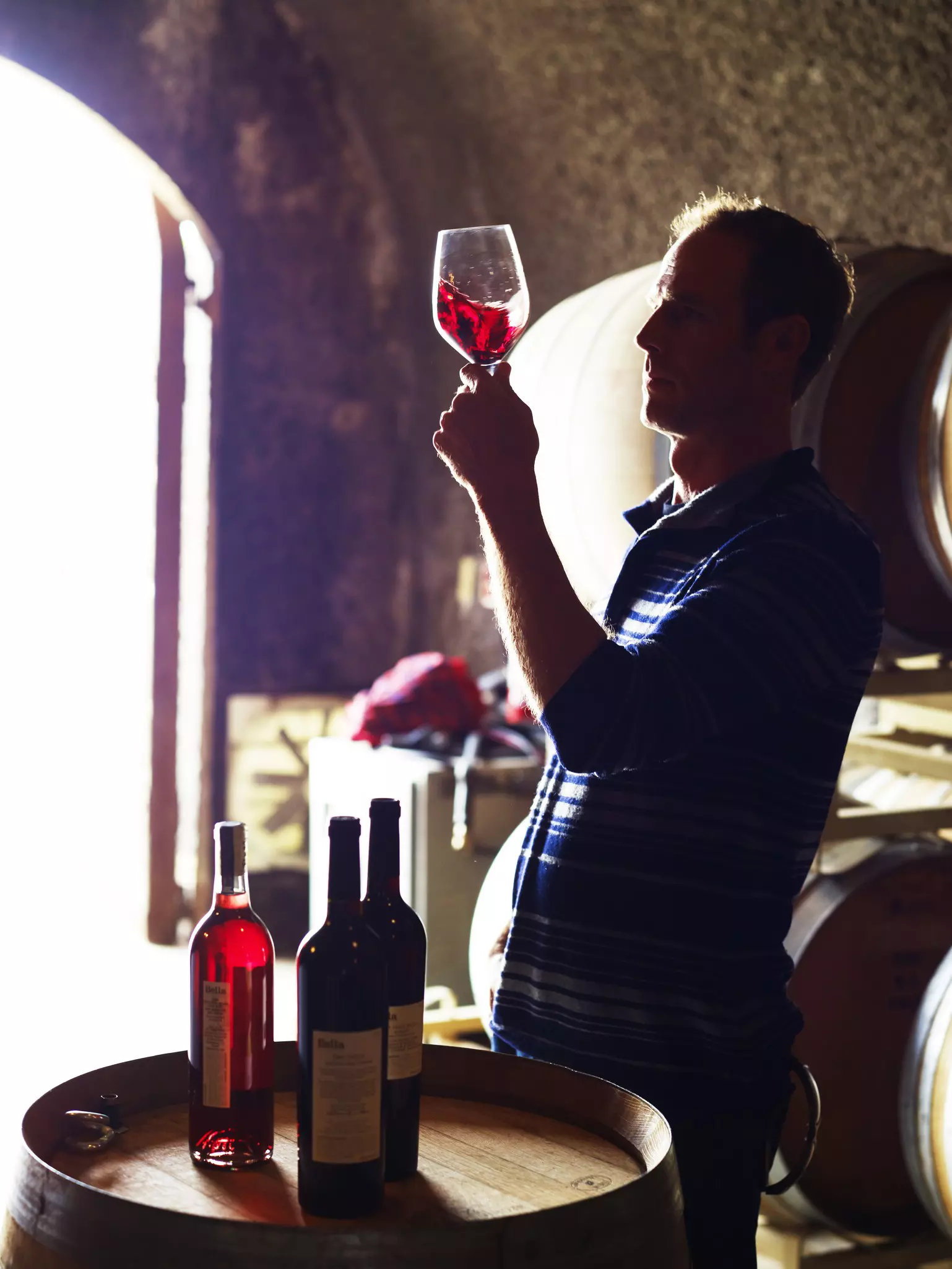Man holds a glass of red wine
