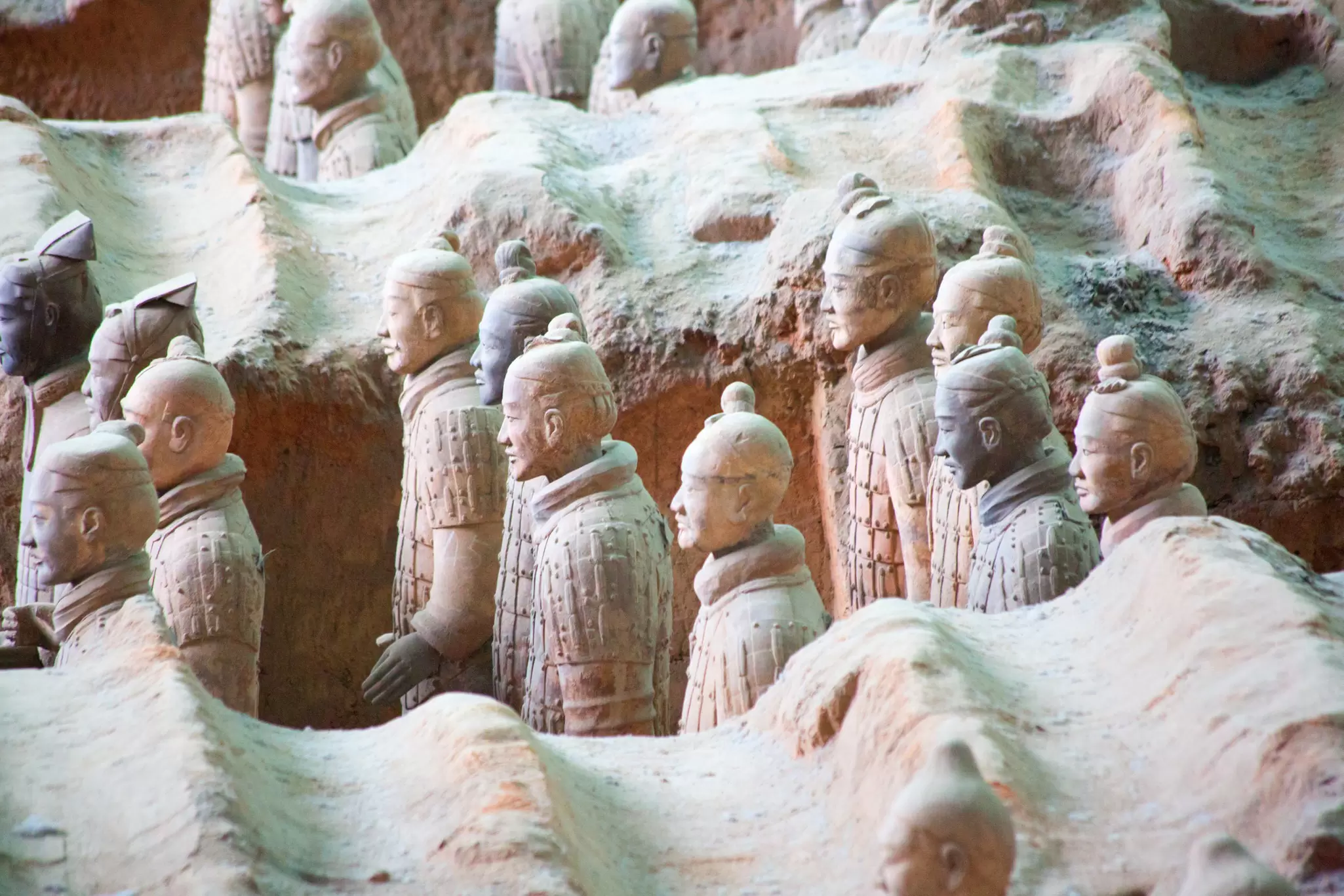 Clay life-size figures standing in formation as an army: the Army of Terracotta Warriors in Xi'an, China.
