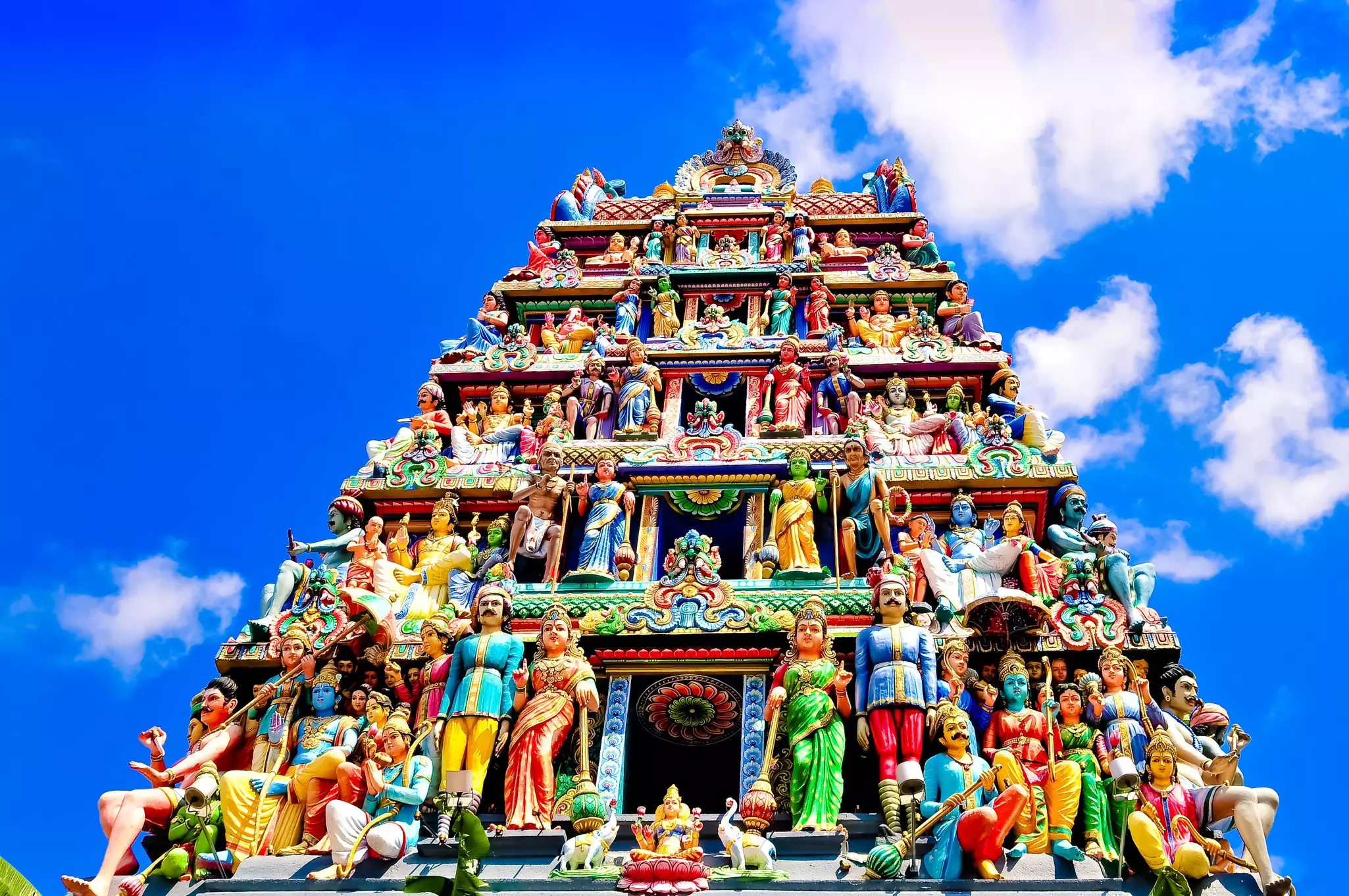 A closeup of the Sri Mariamman Temple, featuring sculptures of deities and mythological figures