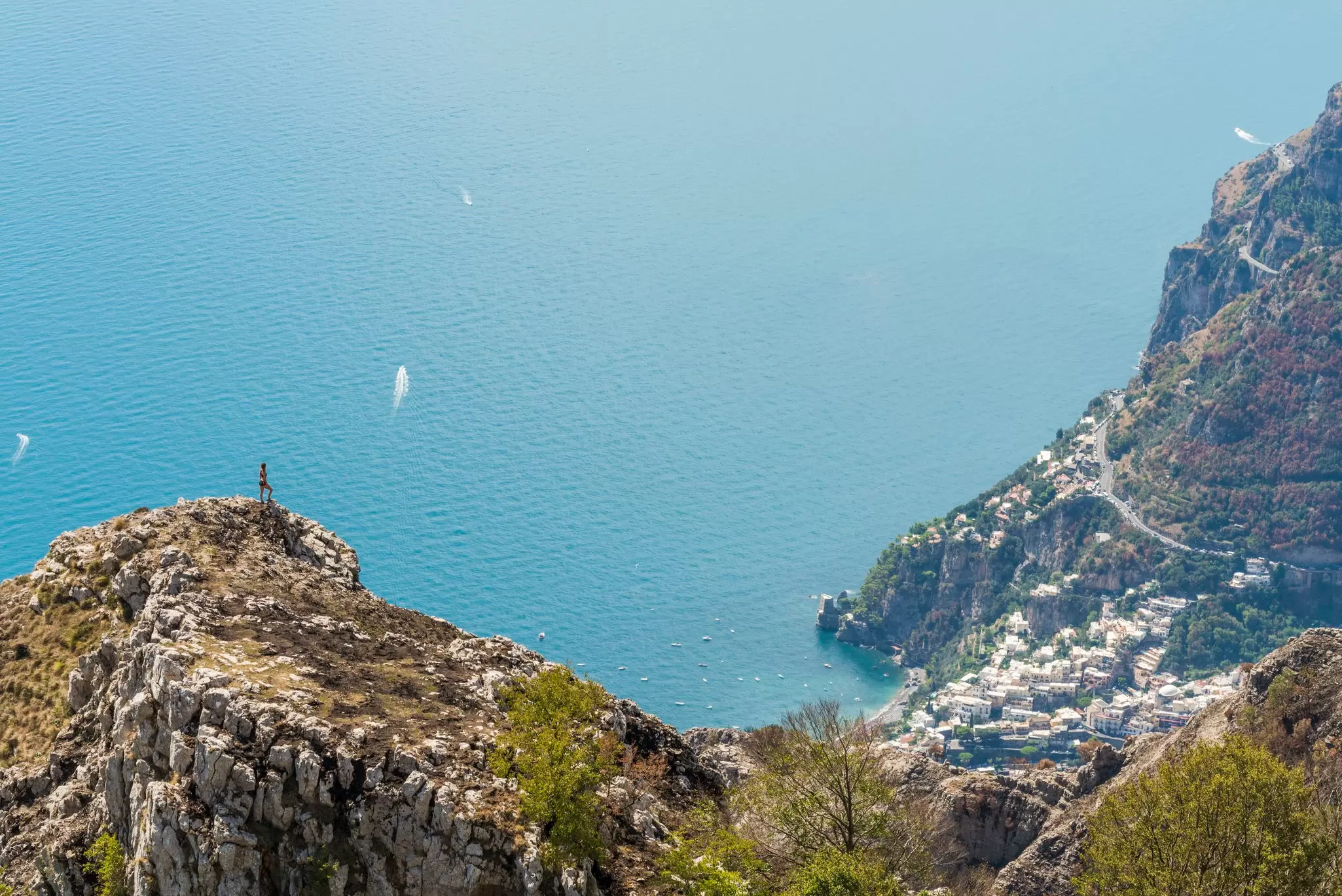 A hiker enjoying spectacular views over the Amalfi Coast. Andrea Comi / Getty Images