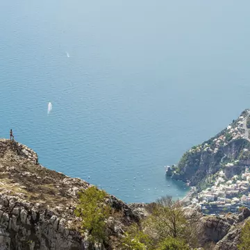 A hiker enjoying spectacular views over the Amalfi Coast. Andrea Comi / Getty Images