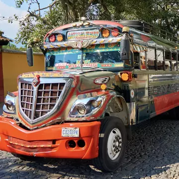 In Guatemala, make like the locals do and catch a reliable if slow (and always decked-out) “chicken bus.” Shutterstock