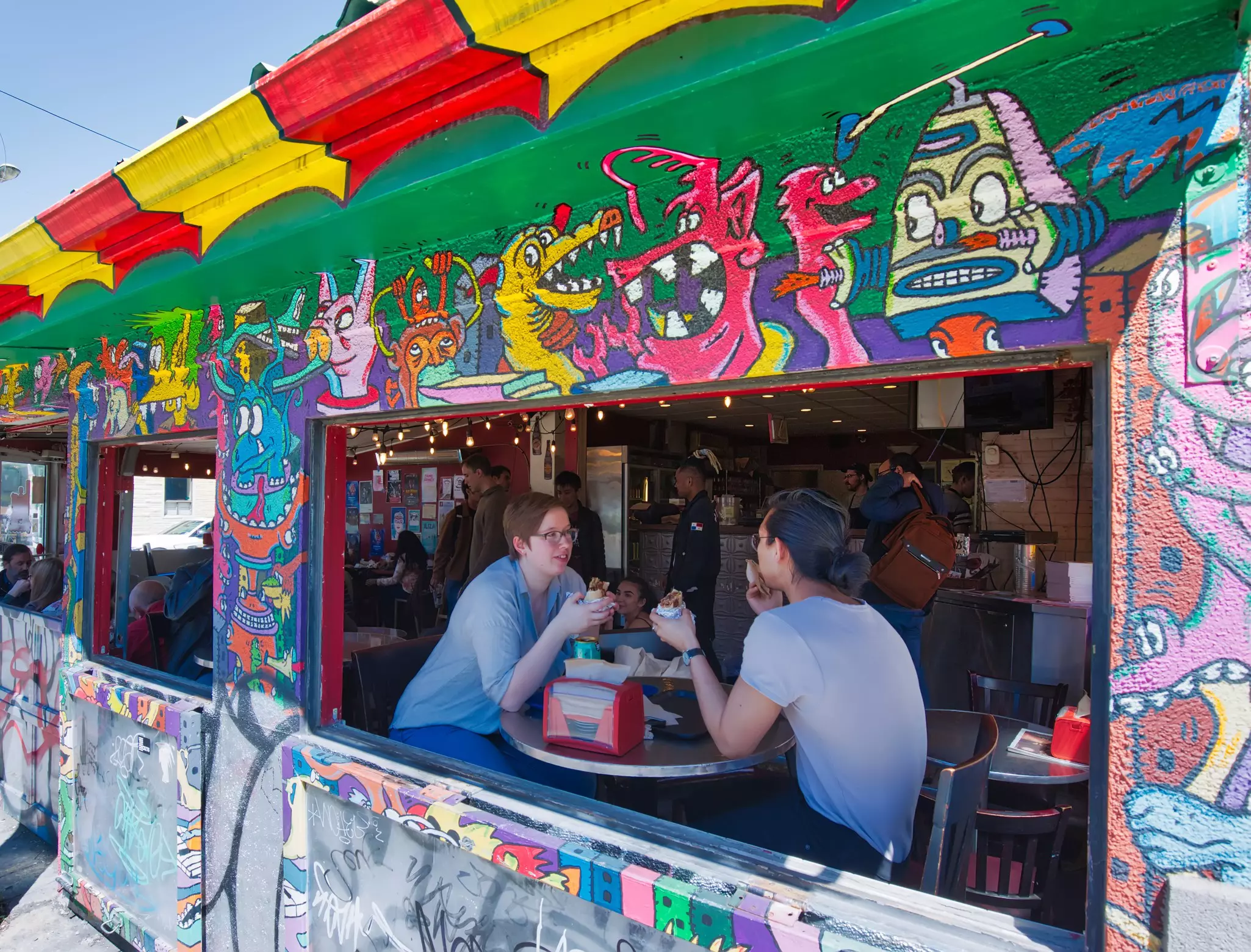 People eating at a playfully decorated diner in Kensington Market, Canada