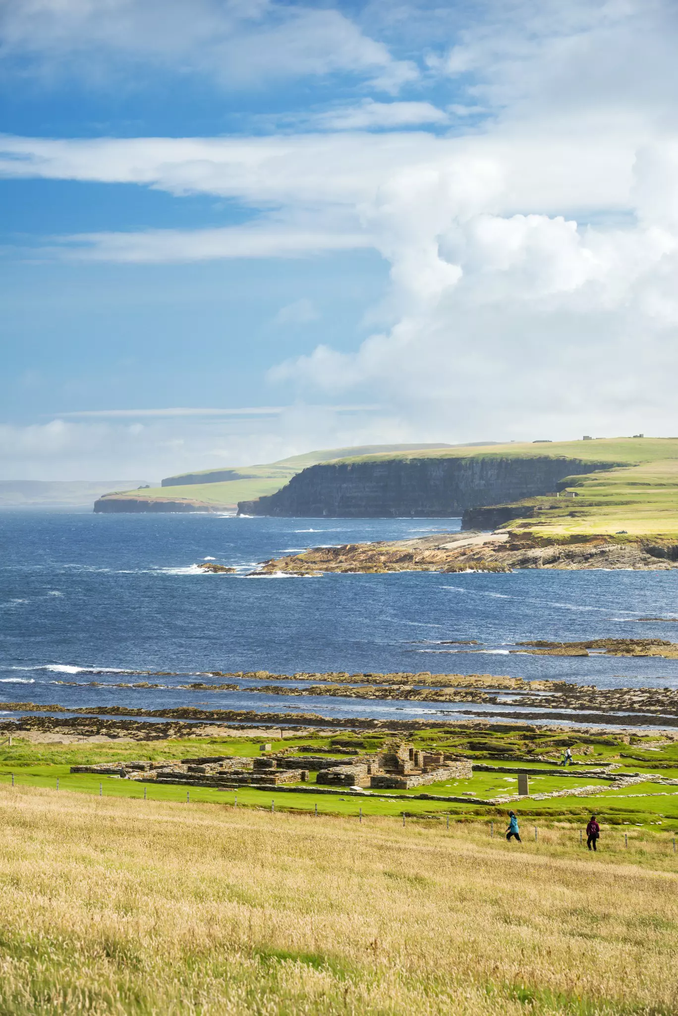 Remains of settlement on Brough of Birsay with the cliffs of mainland beyond.