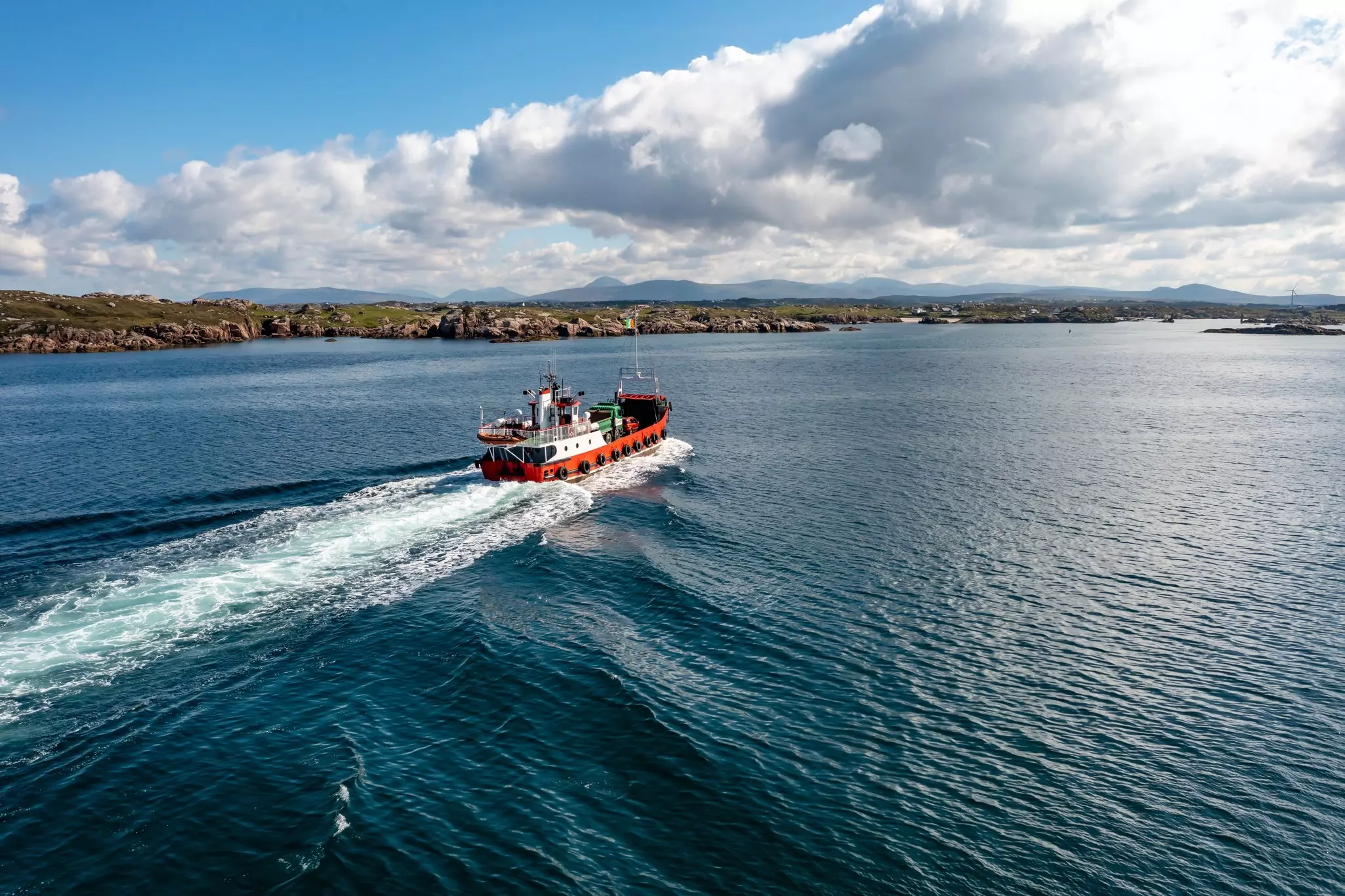 The red Arranmore ferry leaving the island towards Burtonport, County Donegal. 