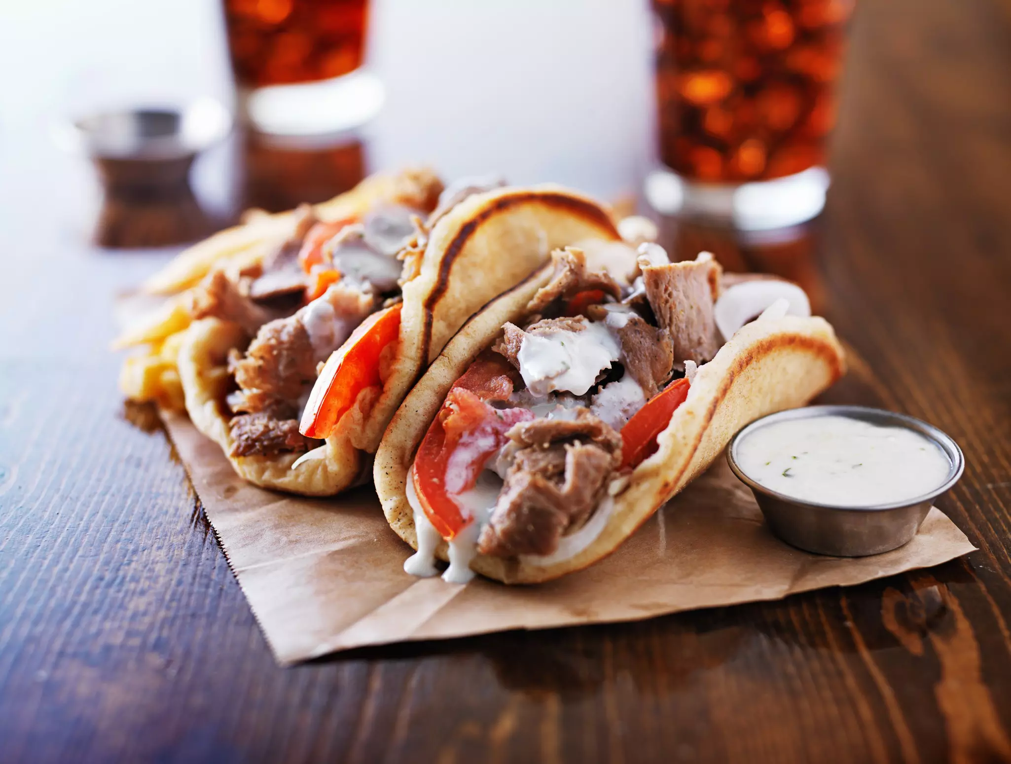 Greek gyros served with tzatziki sauce and fries.
