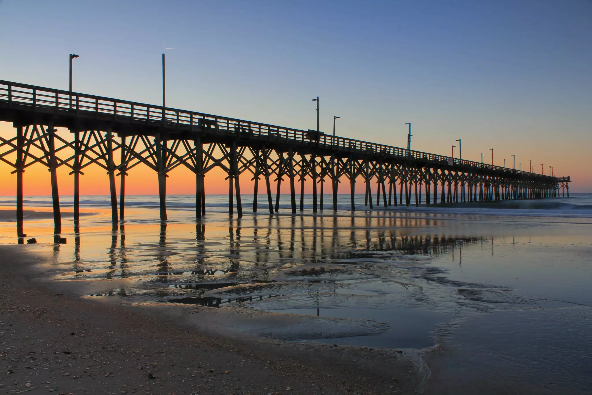 Sunrise at Surf City Pier on Topsail Island, North Carolina.