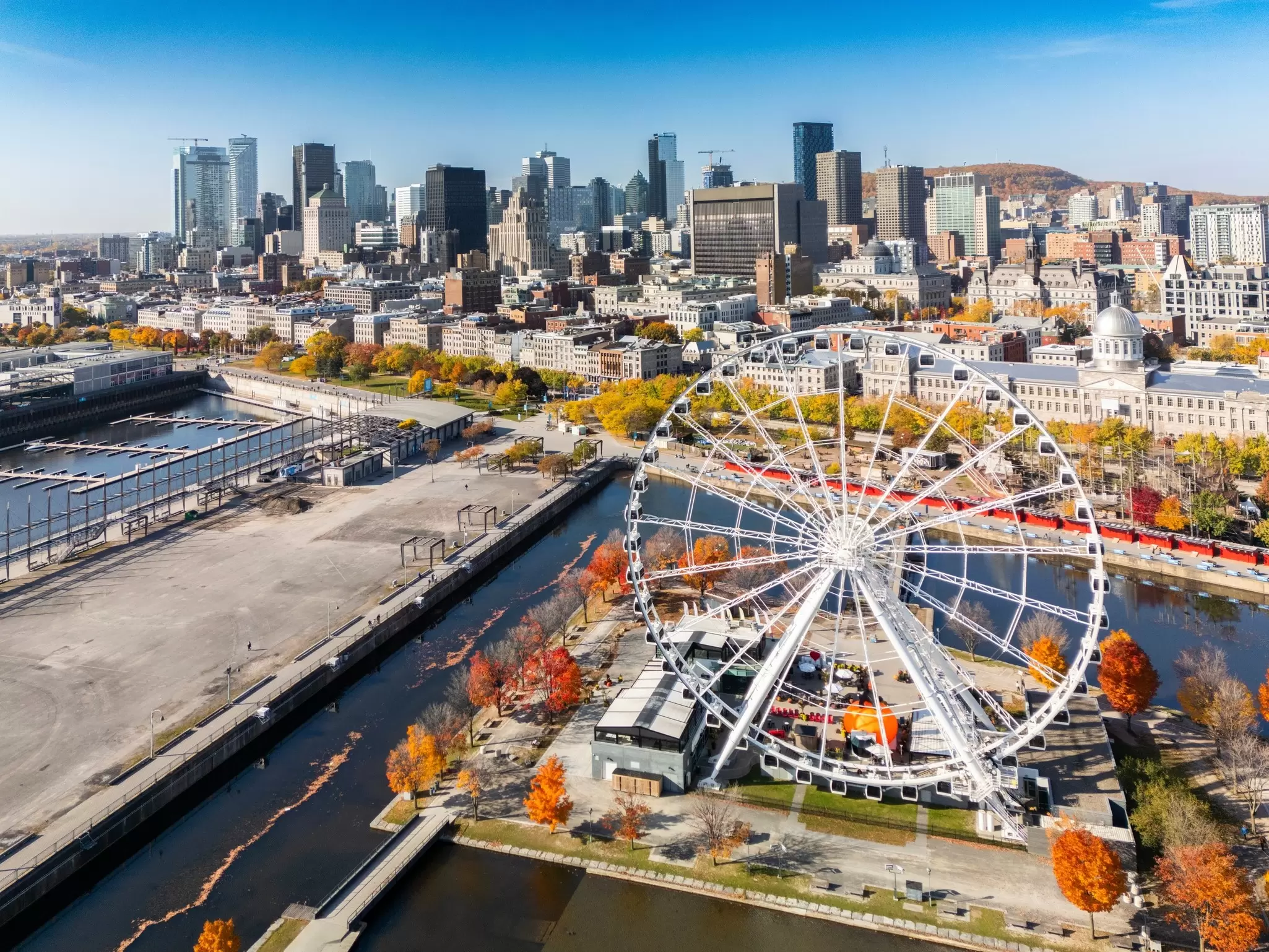 A view of the old port area in Montréal in fall, with a big wheel in the foreground, Canada.