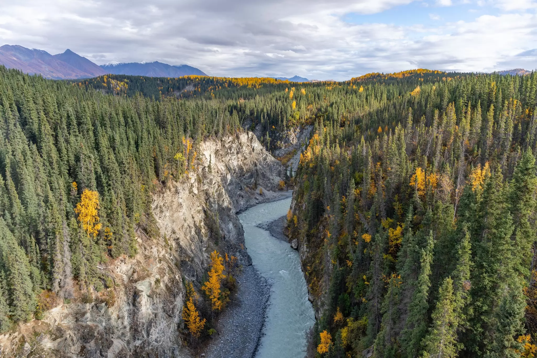 View of Kuskulana River from bridge above with fall colors, Wrangell St Elias National Park.