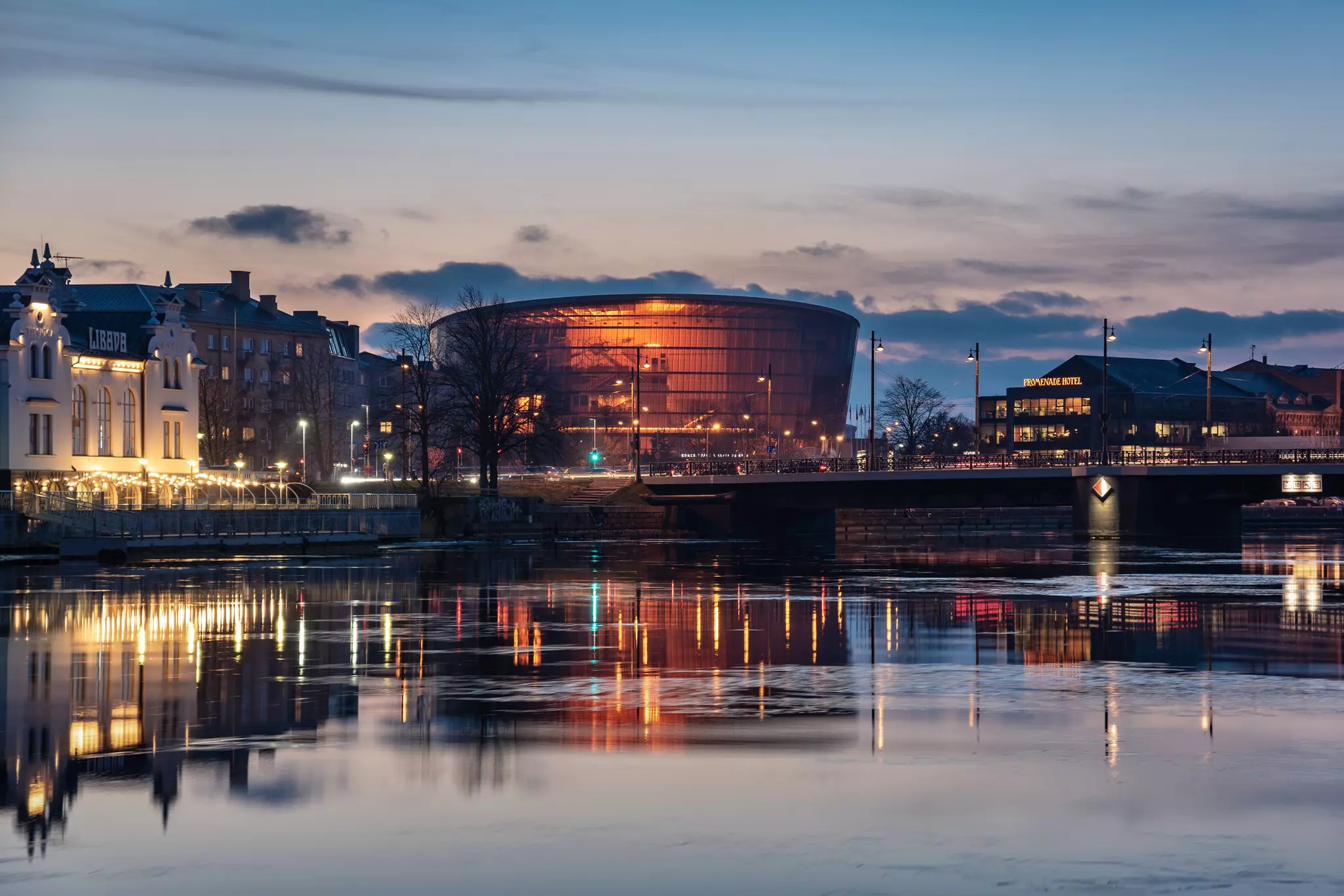 An evening view of the Great Amber concert hall reflected in the water in Liepāja, Latvia.