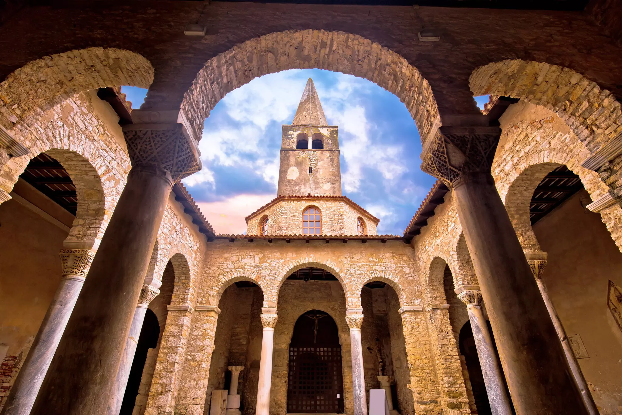 View of the arcades and tower of the Euphrasian Basilica in Porec, Istria, Croatia.