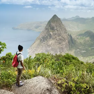 A hiker looks out at Petit Piton from the top of Gros Piton, St Lucia3. Justin Foulkes for Lonely Planet