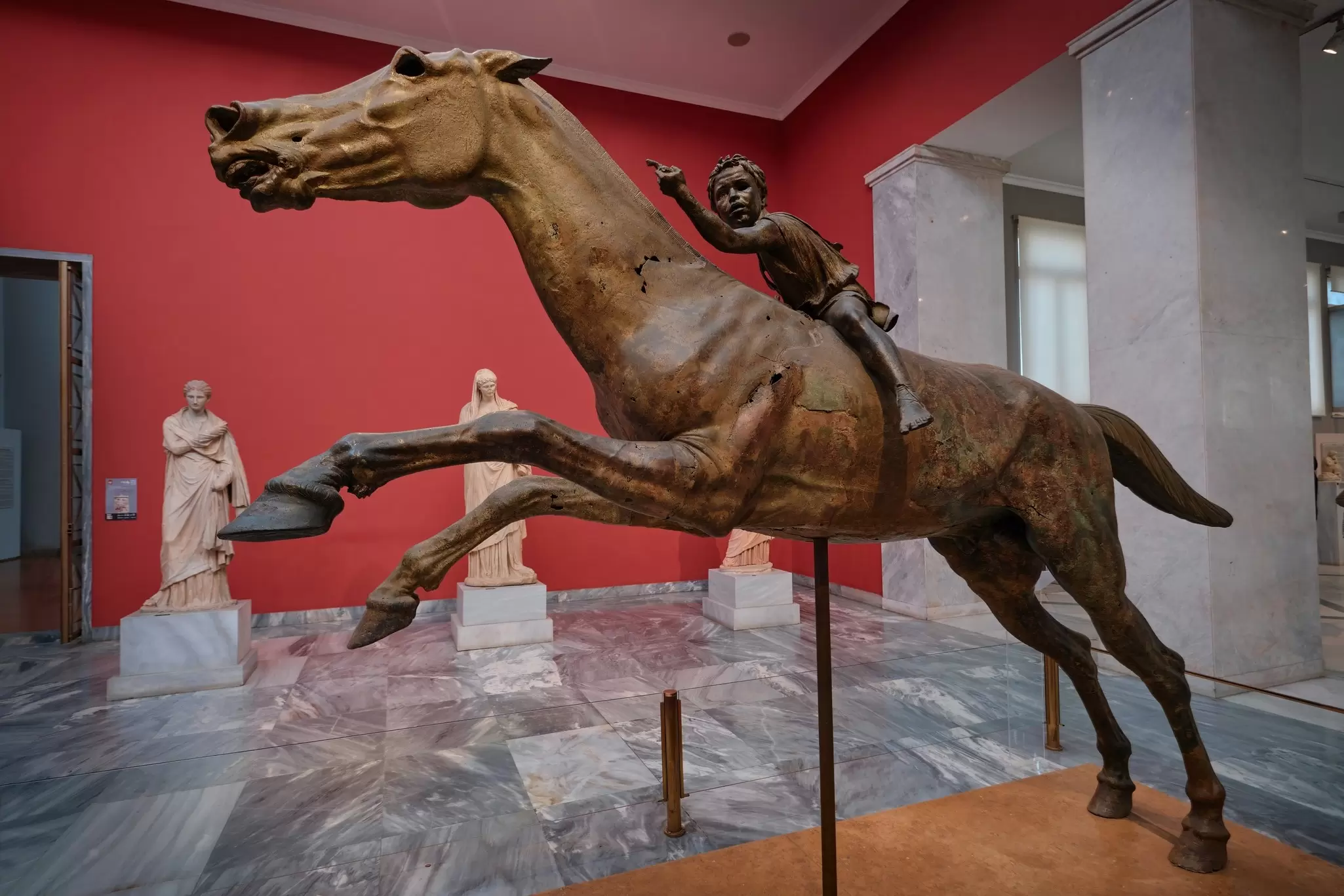 A Bronze Statue of a Boy Riding a Race Horse on Display in the National Archaeological Museum.